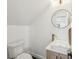 Stylish powder room boasts modern fixtures, including a gold faucet and round mirror at 3087 Alston Dr, Decatur, GA 30032