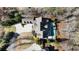 Beautiful home featuring a large backyard pool, mature trees, and a long drive, seen from an aerial view at 230 Hardscrabble Rd, Roswell, GA 30075