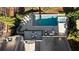 An aerial view of a pool and spa surrounded by lounge chairs and dining and living spaces at 230 Hardscrabble Rd, Roswell, GA 30075