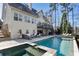 Beautiful backyard with a luxurious in-ground pool, hot tub, patio, and outdoor seating area at 230 Hardscrabble Rd, Roswell, GA 30075