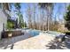 Backyard with a swimming pool, hot tub, stone patio, and lounge seating at 230 Hardscrabble Rd, Roswell, GA 30075