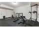 Home gym with dark floors, weight-lifting equipment, and plenty of space to train at 230 Hardscrabble Rd, Roswell, GA 30075