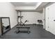 Minimalist basement featuring rubber flooring, a workout station, and ample lighting at 230 Hardscrabble Rd, Roswell, GA 30075