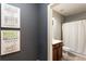Cozy bathroom featuring a shower with stylish curtain, and decorative wall art at 230 Hardscrabble Rd, Roswell, GA 30075