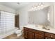Well-lit bathroom featuring a vanity, a shower-tub combo, and modern fixtures for a functional space at 230 Hardscrabble Rd, Roswell, GA 30075
