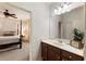 Bathroom with white countertops, brown cabinets, and a view into the bedroom with a four-poster bed at 230 Hardscrabble Rd, Roswell, GA 30075