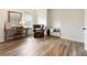 Bright bedroom featuring natural light, hardwood floors, a work desk, and a lounger at 230 Hardscrabble Rd, Roswell, GA 30075