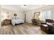 Spacious bedroom featuring ample natural light, a seating area, and a vanity at 230 Hardscrabble Rd, Roswell, GA 30075