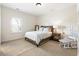 Cozy bedroom with neutral carpet, a comfortable bed, and a window letting in natural light at 230 Hardscrabble Rd, Roswell, GA 30075