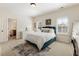 Bright bedroom featuring a comfortable bed, a desk, and natural light creating an inviting space at 230 Hardscrabble Rd, Roswell, GA 30075