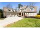 Charming two-story home with a three-car garage and well-manicured lawn at 230 Hardscrabble Rd, Roswell, GA 30075