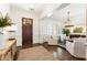 Elegant foyer with hardwood floors, a stylish rug, and a view into the living room at 230 Hardscrabble Rd, Roswell, GA 30075