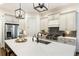Kitchen featuring an island, stainless steel appliances, and white cabinets at 230 Hardscrabble Rd, Roswell, GA 30075