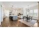 Open kitchen featuring a large island with barstool seating and a dining table with natural lighting at 230 Hardscrabble Rd, Roswell, GA 30075