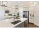 Bright kitchen features stainless appliances, white cabinets, gray backsplash and a quartz countertop island at 230 Hardscrabble Rd, Roswell, GA 30075