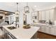 Kitchen island with stainless appliances, quartz countertops, and views into the living area at 230 Hardscrabble Rd, Roswell, GA 30075