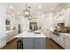 Modern kitchen features custom white cabinets, stainless steel appliances, large island with quartz countertop, and pendant lighting at 230 Hardscrabble Rd, Roswell, GA 30075