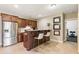 Kitchenette area with stainless steel appliances, a granite countertop, bar seating and brown cabinets at 230 Hardscrabble Rd, Roswell, GA 30075
