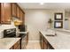 Kitchenette with stainless steel appliances, granite counters, and brown cabinets at 230 Hardscrabble Rd, Roswell, GA 30075