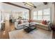 Open concept living area with a comfortable sectional couch flowing into the kitchen and dining area at 230 Hardscrabble Rd, Roswell, GA 30075