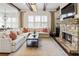 Comfortable living room featuring stone fireplace, hardwood floors and a large window at 230 Hardscrabble Rd, Roswell, GA 30075