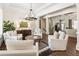 Spacious living room featuring white armchairs, stylish decor, and hardwood floors at 230 Hardscrabble Rd, Roswell, GA 30075