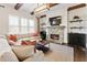 Living room with a stone fireplace, wooden beams and a comfy sectional sofa at 230 Hardscrabble Rd, Roswell, GA 30075