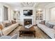 Bright living room featuring fireplace, custom built-ins, and comfortable seating at 230 Hardscrabble Rd, Roswell, GA 30075
