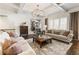 Spacious living room featuring coffered ceilings, modern lighting, and hardwood floors at 230 Hardscrabble Rd, Roswell, GA 30075