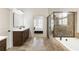 Contemporary bathroom featuring a soaking tub, glass enclosed shower, and a spacious vanity at 230 Hardscrabble Rd, Roswell, GA 30075
