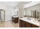 Bright main bathroom with double vanities, and large mirrors, offering a spa-like experience at 230 Hardscrabble Rd, Roswell, GA 30075