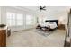 Spacious main bedroom features carpet, tray ceiling, a ceiling fan, large windows and nice furniture at 230 Hardscrabble Rd, Roswell, GA 30075