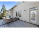 Outdoor patio with a round table and wicker chairs with access to the home's interior at 230 Hardscrabble Rd, Roswell, GA 30075