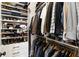 Efficient walk-in closet with custom shelving and hanging racks, providing ample storage for clothing and accessories at 230 Hardscrabble Rd, Roswell, GA 30075