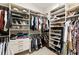 Spacious walk-in closet with custom shelving and ample storage space for clothes, shoes, and accessories at 230 Hardscrabble Rd, Roswell, GA 30075