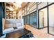 Bright lobby area with light wood floors, a comfortable sofa, and a view of conference rooms with glass doors at 2425 Peachtree Ne Rd # 505, Atlanta, GA 30305