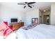 Bright bedroom features a ceiling fan, wood floors, a full-sized bed, and access to the en suite bathroom at 2479 Peachtree Ne Rd # 104, Atlanta, GA 30305