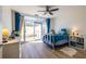 Bedroom with wood floors, ceiling fan, and sliding glass door to an outdoor patio at 2479 Peachtree Ne Rd # 104, Atlanta, GA 30305