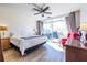 Bright bedroom featuring a large bed, light wood floors and access to the balcony at 2479 Peachtree Ne Rd # 104, Atlanta, GA 30305