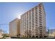 High-rise building with a modern facade, surrounded by mature trees, offering urban living with a touch of nature at 2479 Peachtree Ne Rd # 104, Atlanta, GA 30305
