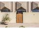 Unique exterior entrance with a wooden gate, stucco walls, and garden planters at 2479 Peachtree Ne Rd # 104, Atlanta, GA 30305