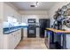Modern kitchen features white cabinets, black appliances, and stylish countertops at 2479 Peachtree Ne Rd # 104, Atlanta, GA 30305