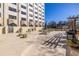 Overhead view of the outdoor patio with grill, seating, and beautiful planters on a sunny day at 2479 Peachtree Ne Rd # 104, Atlanta, GA 30305