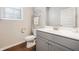 Well-lit bathroom features white countertops, tile floor, and gray cabinets at 3030 Westpoint Cir, Snellville, GA 30078