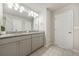 Bright bathroom features double vanity with granite countertop and updated fixtures at 3030 Westpoint Cir, Snellville, GA 30078