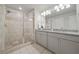 Bathroom featuring granite countertop sinks with a glass-enclosed shower at 3030 Westpoint Cir, Snellville, GA 30078