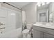 Bathroom with shower/tub combo, white cabinets, and a large mirror at 3030 Westpoint Cir, Snellville, GA 30078