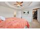 Bedroom featuring tray ceilings, a TV, and a walk-in closet at 3030 Westpoint Cir, Snellville, GA 30078