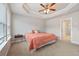 Bedroom featuring tray ceilings and next to an ensuite bathroom at 3030 Westpoint Cir, Snellville, GA 30078