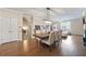 An open-concept dining room featuring hardwood floors, a modern chandelier, and plenty of natural light at 3030 Westpoint Cir, Snellville, GA 30078